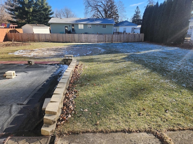 view of yard with fence and driveway