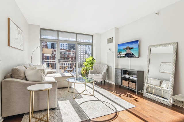 living room with hardwood / wood-style flooring and expansive windows