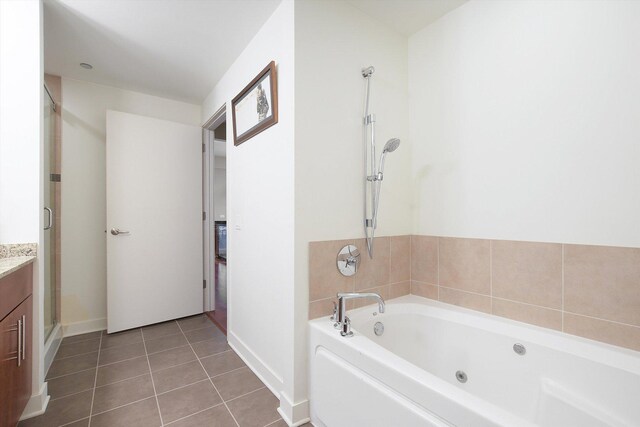 bathroom with separate shower and tub, tile patterned flooring, and vanity