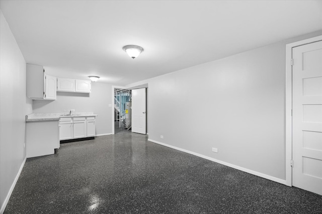 unfurnished living room featuring sink