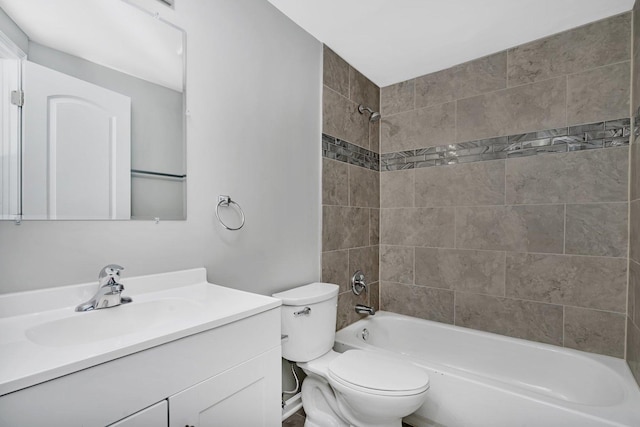 full bathroom with tiled shower / bath combo, toilet, and vanity