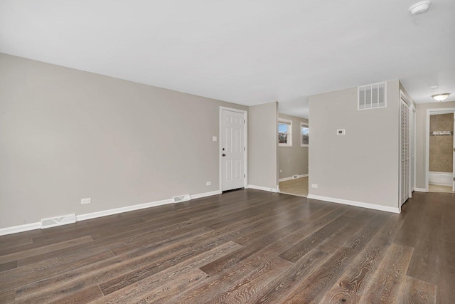 empty room with dark hardwood / wood-style floors