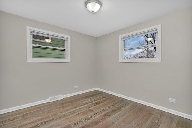 empty room with hardwood / wood-style flooring