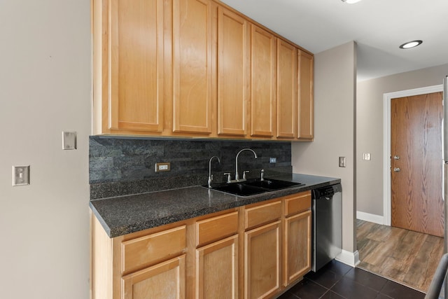 kitchen with sink, dark tile patterned floors, backsplash, stainless steel dishwasher, and light brown cabinets