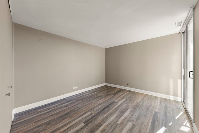 unfurnished room with dark hardwood / wood-style floors