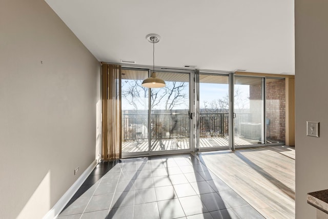 unfurnished dining area with expansive windows and tile patterned floors