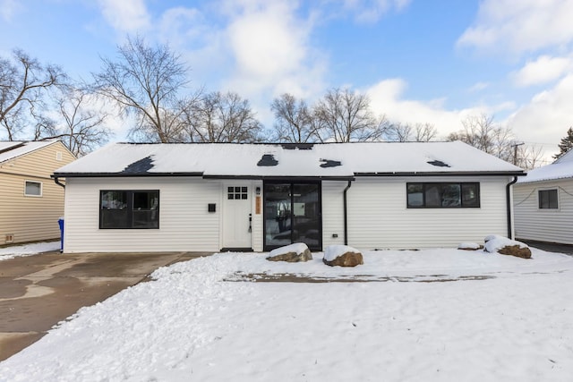 view of snow covered back of property