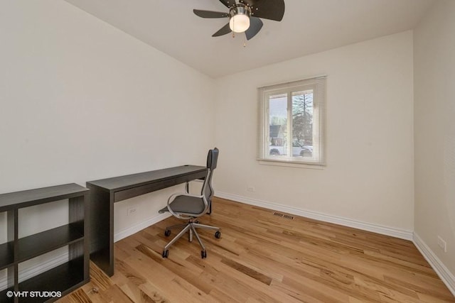 office with ceiling fan and light hardwood / wood-style floors