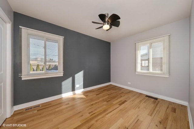 empty room with ceiling fan and light wood-type flooring