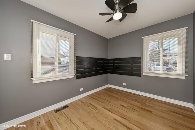 spare room featuring hardwood / wood-style flooring and ceiling fan