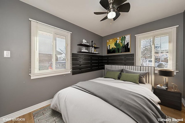 bedroom with hardwood / wood-style floors and ceiling fan