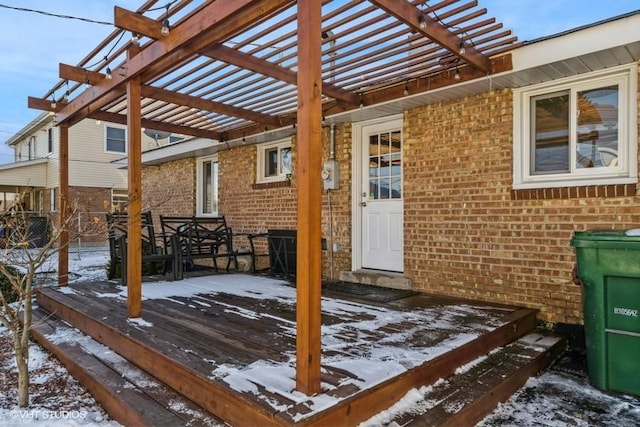 snow covered deck with a pergola