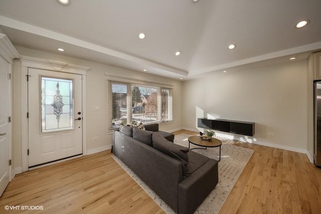 living room with lofted ceiling and light hardwood / wood-style floors