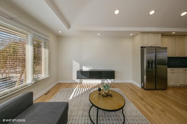 living area with plenty of natural light and light hardwood / wood-style floors