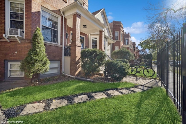 view of side of property with cooling unit and a lawn