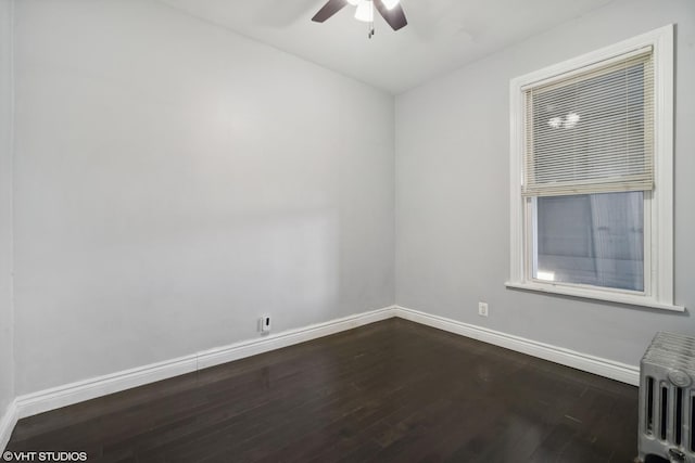 empty room with radiator, ceiling fan, and dark hardwood / wood-style flooring