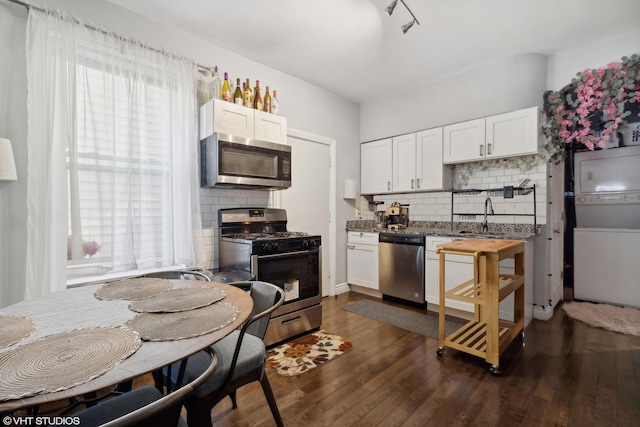 kitchen featuring backsplash, white cabinetry, and stainless steel appliances