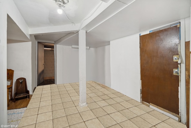 basement featuring light tile patterned flooring