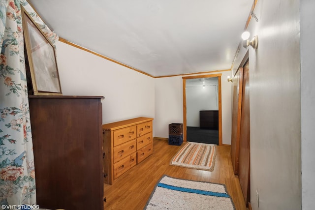 hall featuring light hardwood / wood-style flooring and crown molding