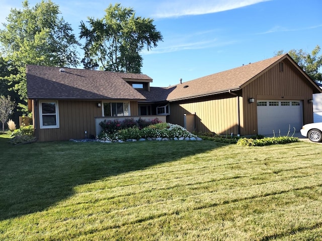 view of front of home with a garage and a front yard