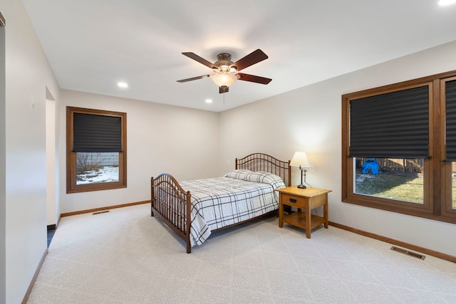 bedroom featuring light colored carpet and ceiling fan