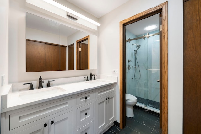 bathroom featuring vanity, toilet, tile patterned floors, and walk in shower