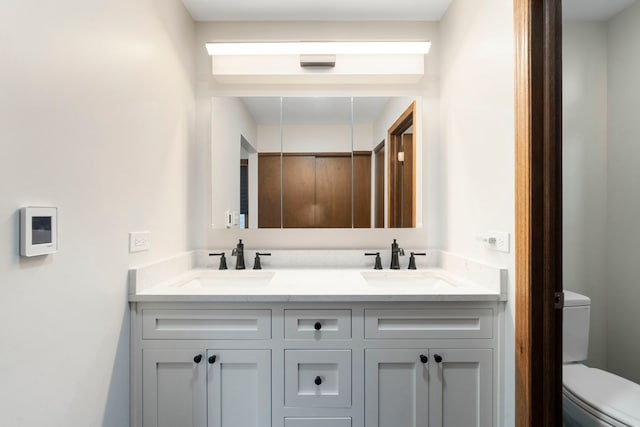 bathroom with vanity and toilet