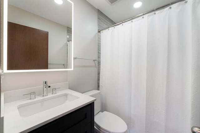 bathroom featuring vanity and toilet