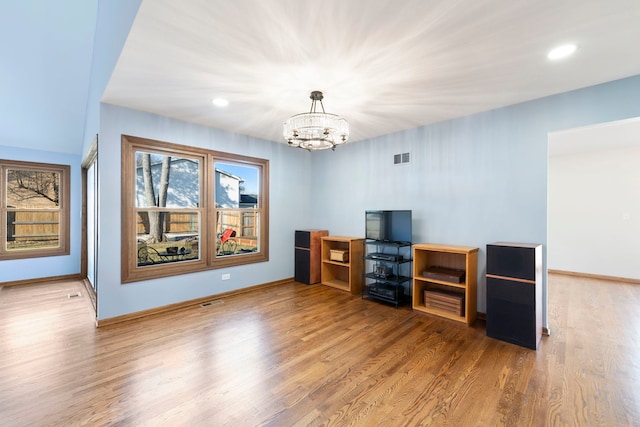 interior space with wood-type flooring and a notable chandelier