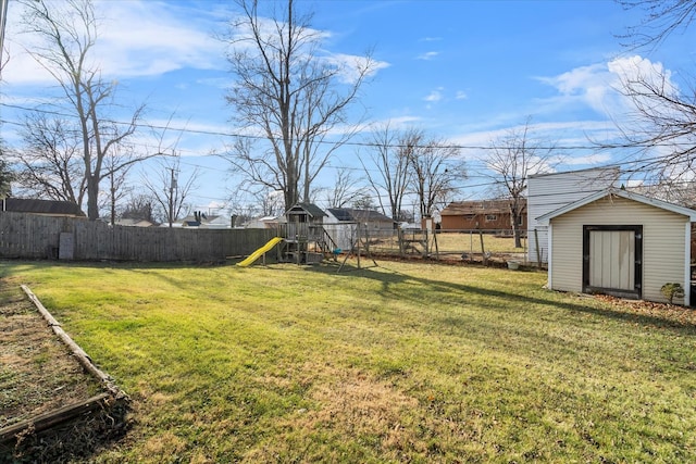 view of yard featuring a playground and a shed