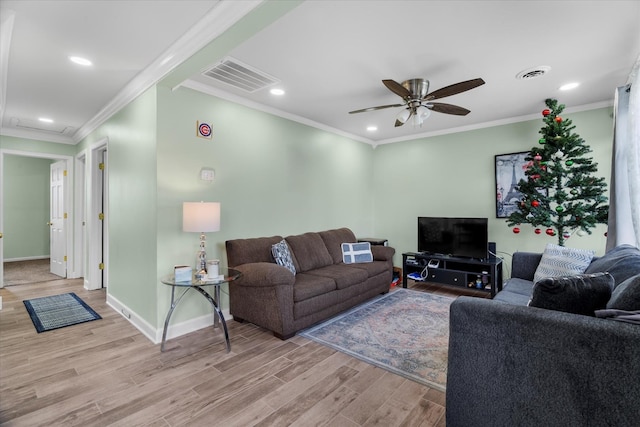 living room featuring crown molding, light hardwood / wood-style flooring, and ceiling fan