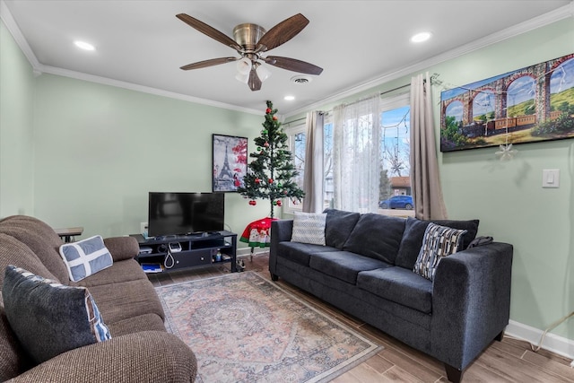 living room featuring ceiling fan and crown molding