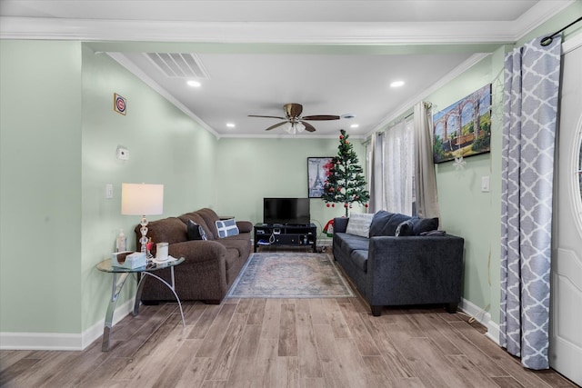 living room featuring crown molding, ceiling fan, and light wood-type flooring