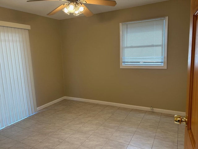 tiled empty room with ceiling fan