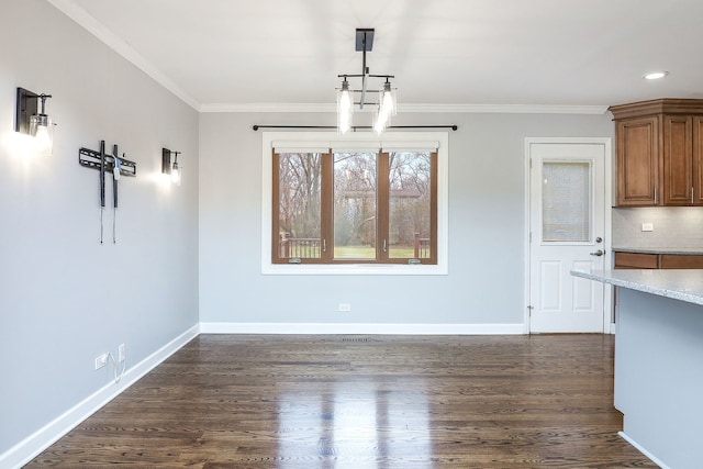 unfurnished dining area with dark wood-type flooring and ornamental molding