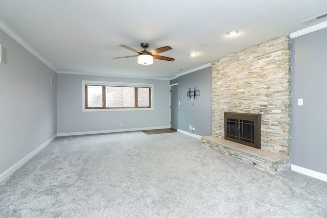 unfurnished living room featuring a fireplace, carpet floors, ceiling fan, and crown molding