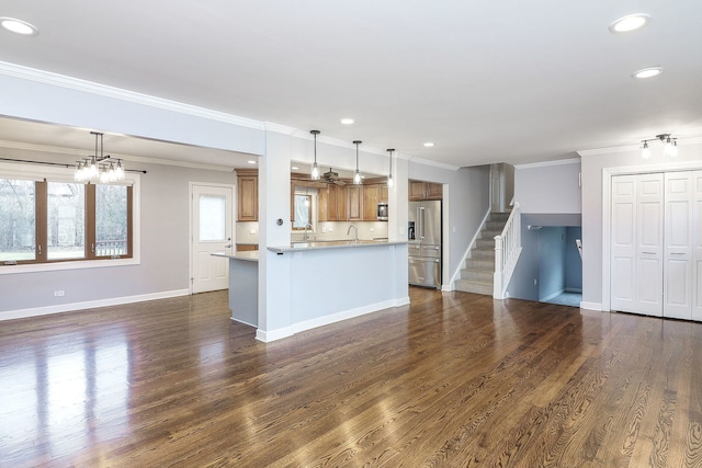 kitchen featuring stainless steel appliances, dark hardwood / wood-style flooring, a kitchen island, and hanging light fixtures