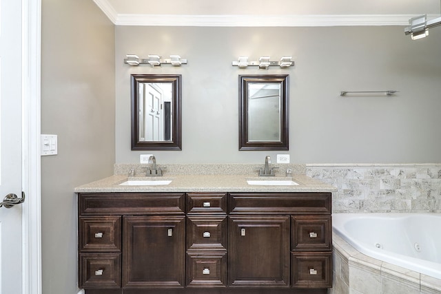 bathroom with vanity, crown molding, and tiled tub