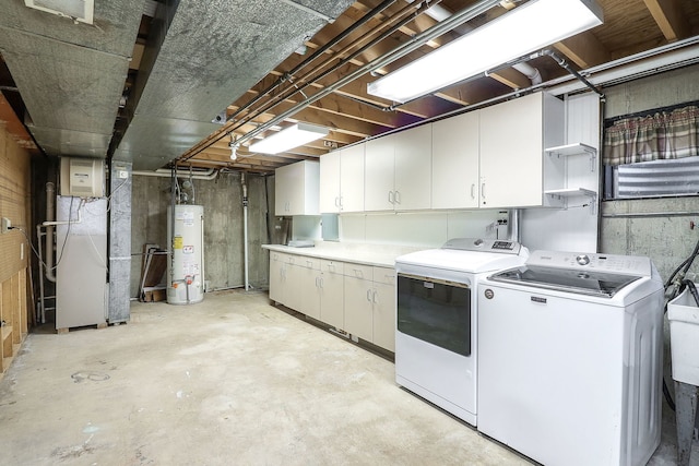 clothes washing area with heating unit, cabinets, gas water heater, and independent washer and dryer