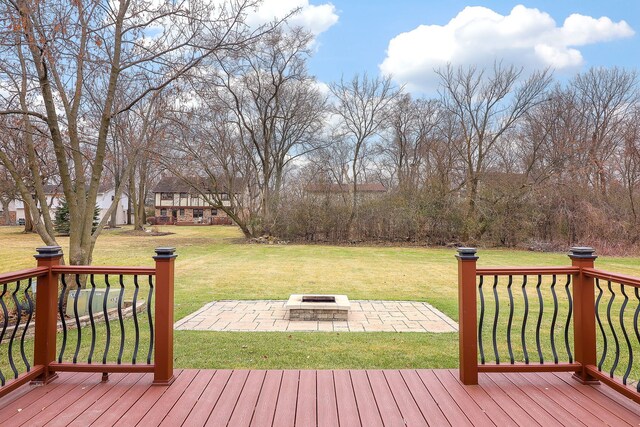 deck with a lawn, a patio area, and an outdoor fire pit