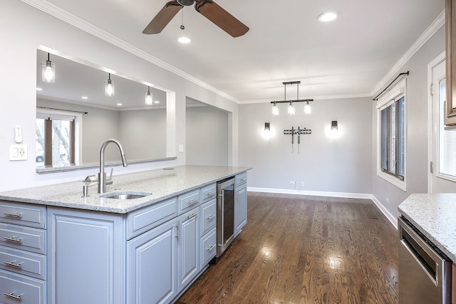 kitchen with light stone countertops, stainless steel dishwasher, dark wood-type flooring, sink, and decorative light fixtures