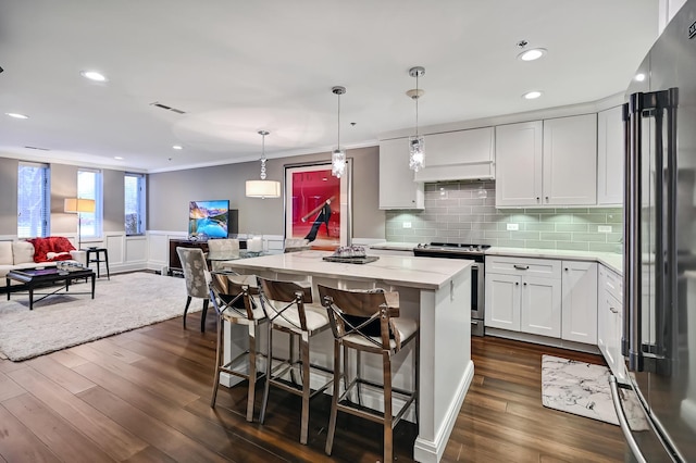 kitchen with light stone countertops, dark wood finished floors, high quality fridge, electric range, and white cabinetry