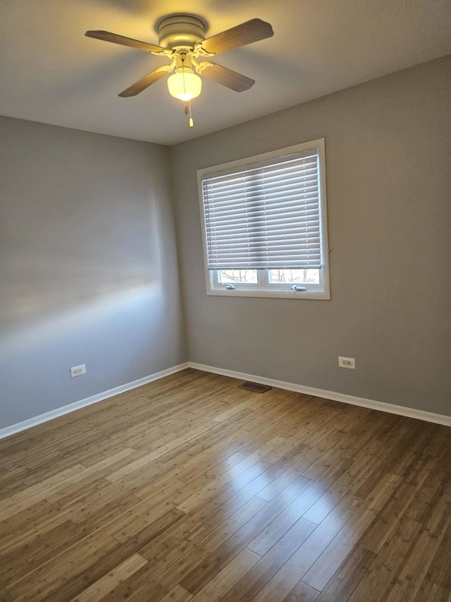 spare room with ceiling fan and hardwood / wood-style floors