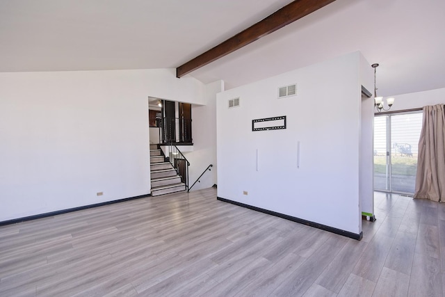 empty room with lofted ceiling with beams, an inviting chandelier, and light hardwood / wood-style flooring