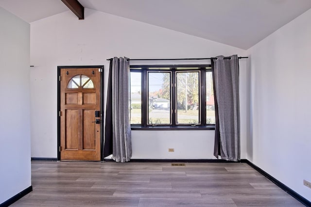 entryway with vaulted ceiling with beams, a healthy amount of sunlight, and light hardwood / wood-style floors