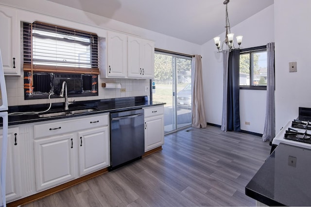 kitchen featuring backsplash, sink, dishwasher, white cabinetry, and lofted ceiling