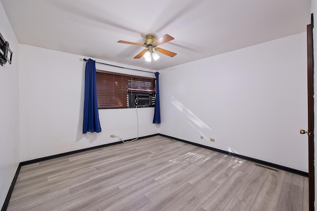 unfurnished room featuring ceiling fan, light hardwood / wood-style floors, and cooling unit