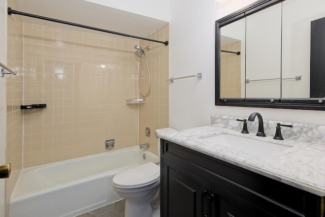 full bathroom featuring tile patterned flooring, vanity, toilet, and tiled shower / bath