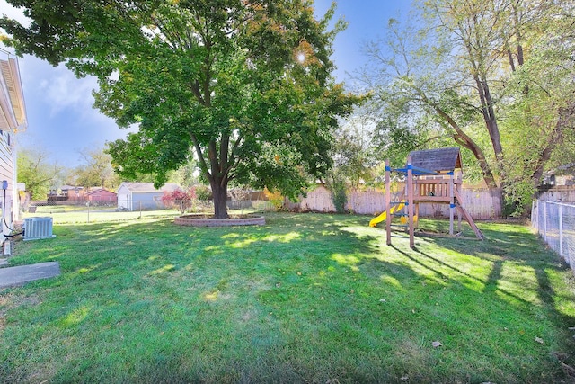 view of yard with central AC unit and a playground