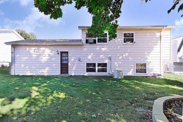 back of property featuring a yard and cooling unit